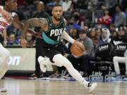 Portland Trail Blazers guard Damian Lillard brings the ball up court during the first half of an NBA basketball game against the Detroit Pistons, Monday, March 6, 2023, in Detroit.