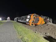 A derailed BNSF train is seen Thursday on a berm along Puget Sound on the Swinomish tribal reservation near Anacortes. There were no injuries but 5,000 gallons of diesel fuel was spilled.