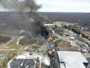FILE - This photo taken with a drone shows portions of a Norfolk and Southern freight train that derailed Friday night in East Palestine, Ohio are still on fire at mid-day Saturday, Feb. 4, 2023. The federal government filed a lawsuit Thursday, March 30, against railroad Norfolk Southern over environmental damage caused by a February derailment on the Ohio-Pennsylvania border that spilled hazardous chemicals into nearby creeks and rivers. (AP Photo/Gene J.