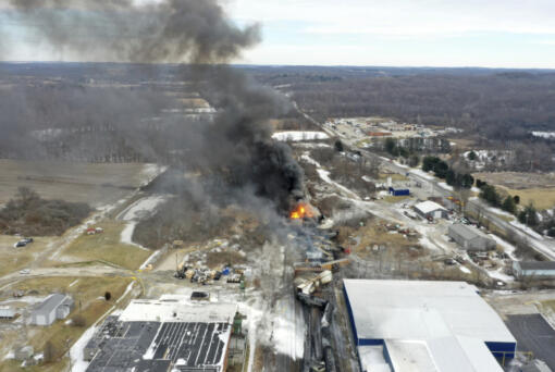 FILE - This photo taken with a drone shows portions of a Norfolk and Southern freight train that derailed Friday night in East Palestine, Ohio are still on fire at mid-day Saturday, Feb. 4, 2023. The federal government filed a lawsuit Thursday, March 30, against railroad Norfolk Southern over environmental damage caused by a February derailment on the Ohio-Pennsylvania border that spilled hazardous chemicals into nearby creeks and rivers. (AP Photo/Gene J.
