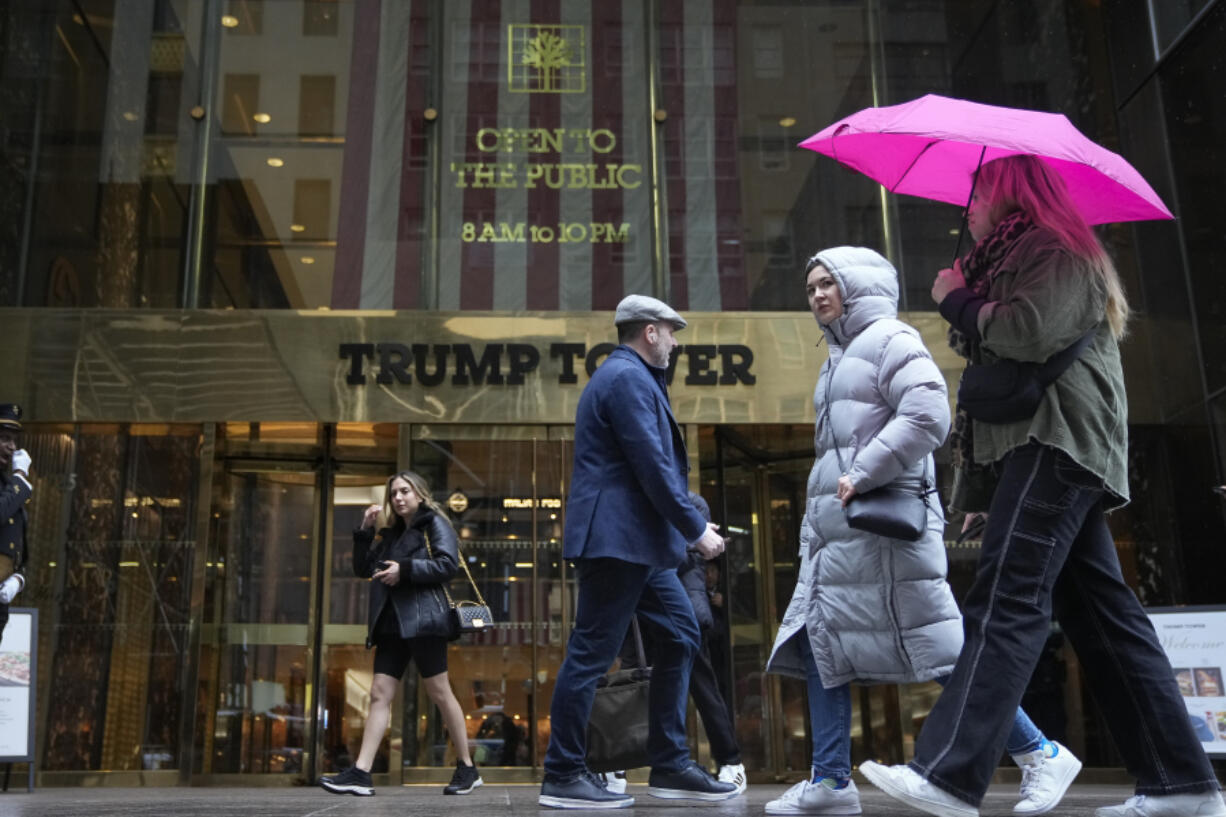 People pass Trump Tower on Thursday, March 23, 2023, in New York.