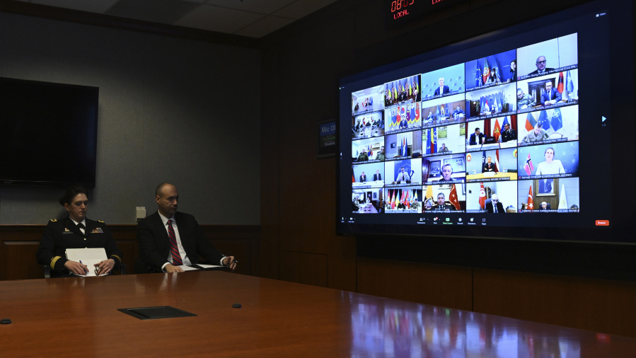 Officials attend a virtual meeting of Ukraine Defense Contact Group, Wednesday, March 15, 2023, at the Pentagon in Washington.