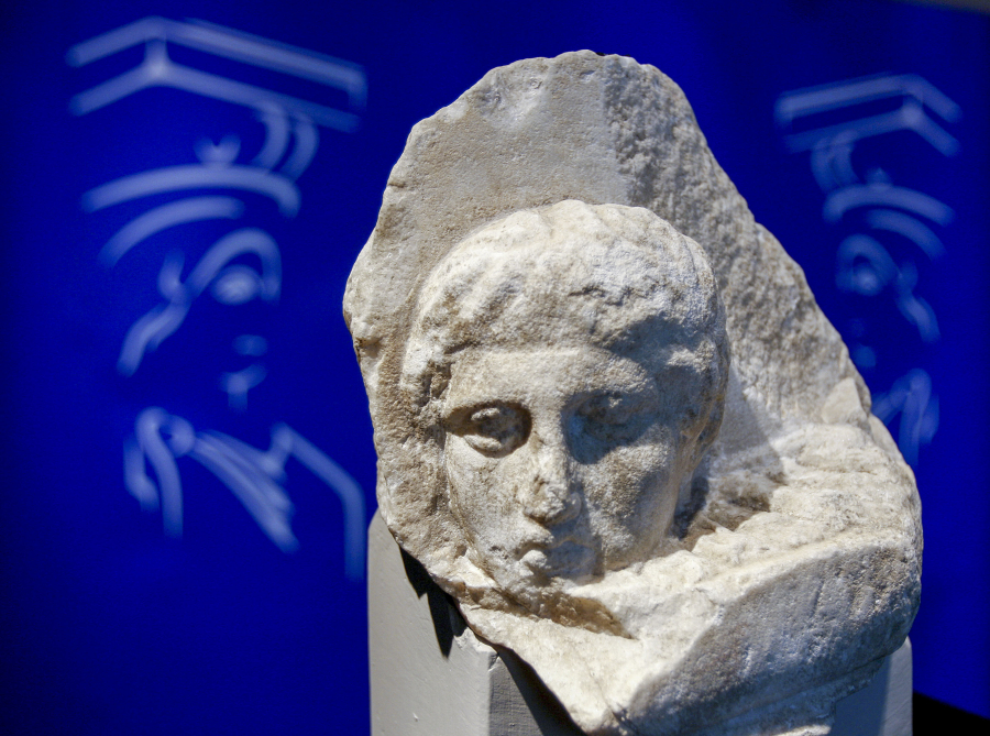 The marble head of a young man, a tiny fragment from the 2,500-year-old sculptured decoration of the Parthenon Temple on the ancient Acropolis, is displayed in 2008 during a presentation to the press at the new Acropolis Museum in Athens.