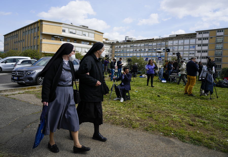 Two nuns walk in front of the Agostino Gemelli University Hospital in Rome, Thursday, March 30, 2023, where Pope Francis was admitted on Wednesday after having suffered breathing problems in recent days and was diagnosed with a respiratory infection.