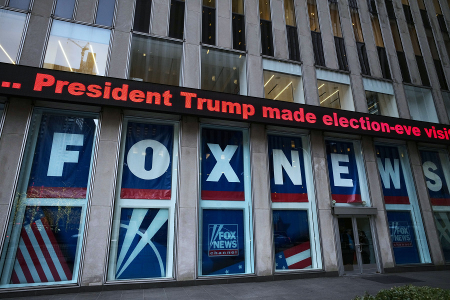 FILE - A headline about President Donald Trump is displayed outside Fox News studios in New York on Nov. 28, 2018. Documents in defamation lawsuit illustrate pressures faced by Fox News journalists in the weeks after the 2020 presidential election. The network was on a collision course between giving its conservative audience what it wanted and reporting uncomfortable truths about then-President Donald Trump and his false fraud claims.