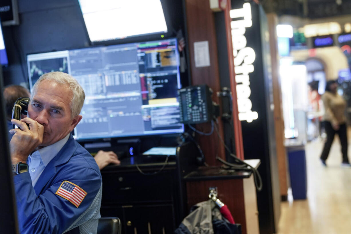 FILE -- Trader Timothy Nick works on the floor at the New York Stock Exchange, Feb. 22, 2023. Average Wall Street bonuses dropped sharply last year  amid lagging profits and recession fears, New York state's comptroller reported Thursday.