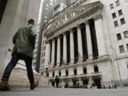 FILE -- People pass the front of the New York Stock Exchange, March 22, 2023.