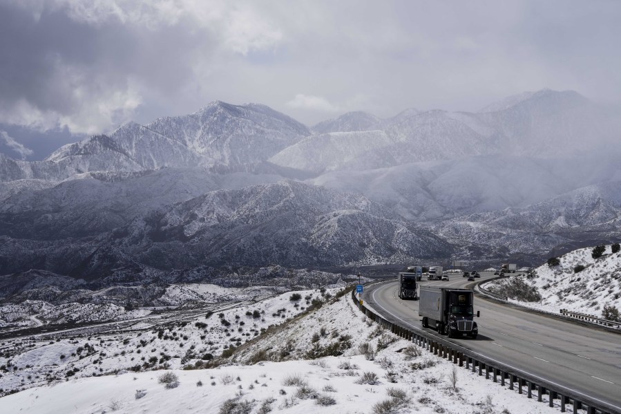 Vehicles make their way along the I-15 as clouds pass through the snow-covered mountains near Hesperia, Calif., Wednesday, March 1, 2023. (AP Photo/Jae C. Hong) (Photos by jae c.