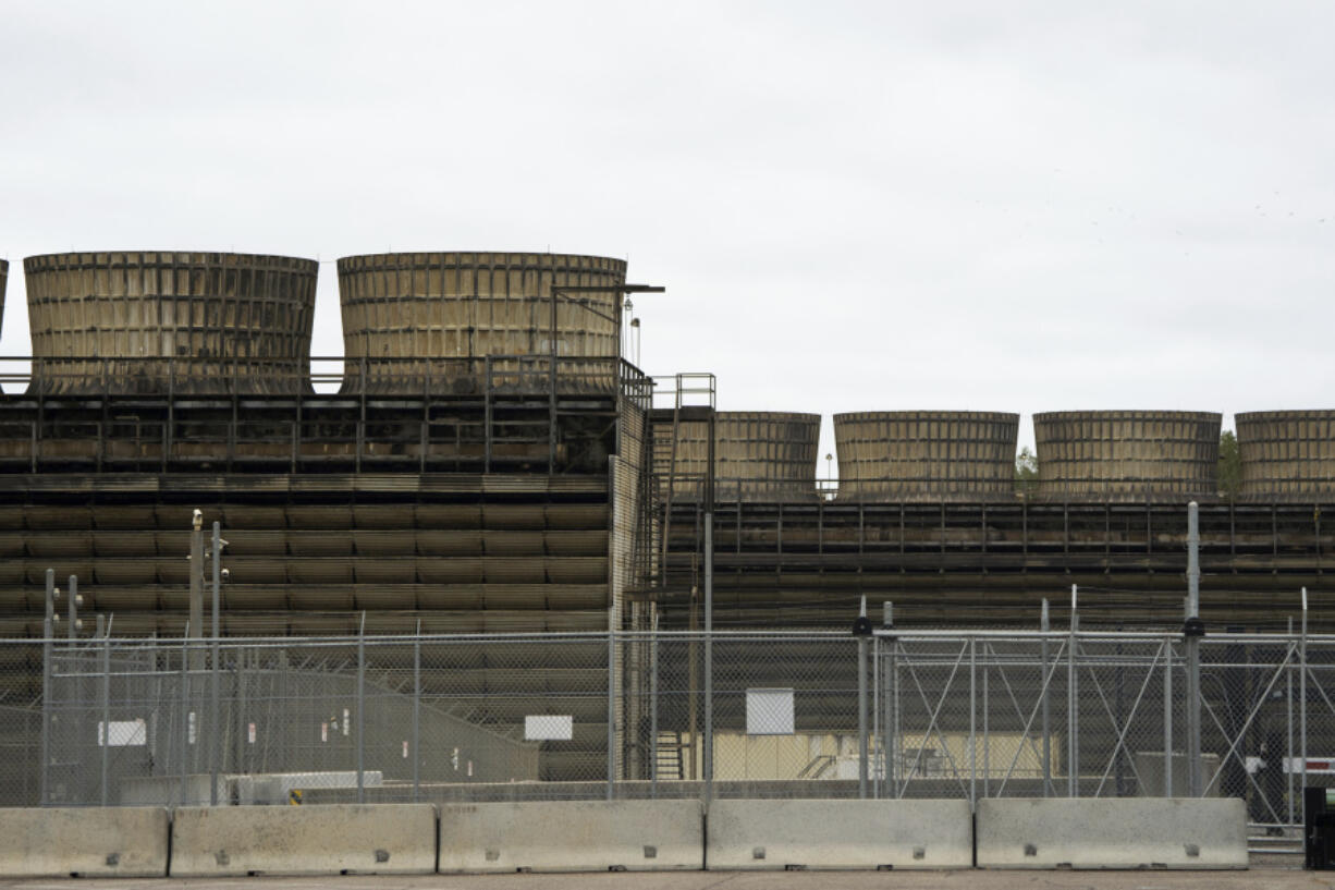 FILE - Cooling towers release heat generated by boiling water reactors at Xcel Energy's Nuclear Generating Plant on Oct. 2, 2019, in Monticello, Minn. Minnesota regulators said Thursday, March 16, 2023, that they're monitoring the cleanup of a leak of 400,000 gallons of radioactive water from Xcel Energy's Monticello nuclear power plant in late November 2022. The company said there's no danger to the public.