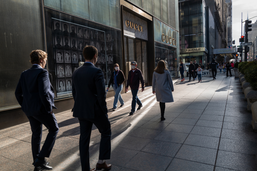 People walk along 5th Avenue in Manhattan on Feb. 15, 2023, in New York City. The average U.S. workweek has dropped by more than a half hour over the last three years, according to a new report.