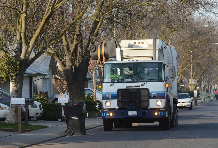 A Gilton Solid Waste Management truck picks up garbage in Modesto, California.