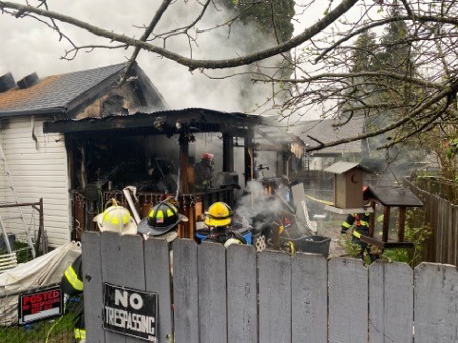 Vancouver firefighters extinguish a house fire Wednesday morning in the Rose Village neighborhood. Two people were taken to an area hospital, and several pets apparently died in the fire.