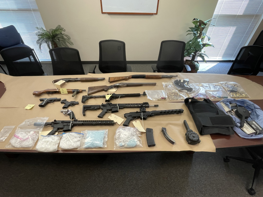 Investigators recovered 11 firearms, more than 2 pounds of methamphetamine, about 5,000 fentanyl pills, cocaine, crack cocaine, body armor, documents related to fraud and other items after serving a search warrant at a La Center residence Friday.