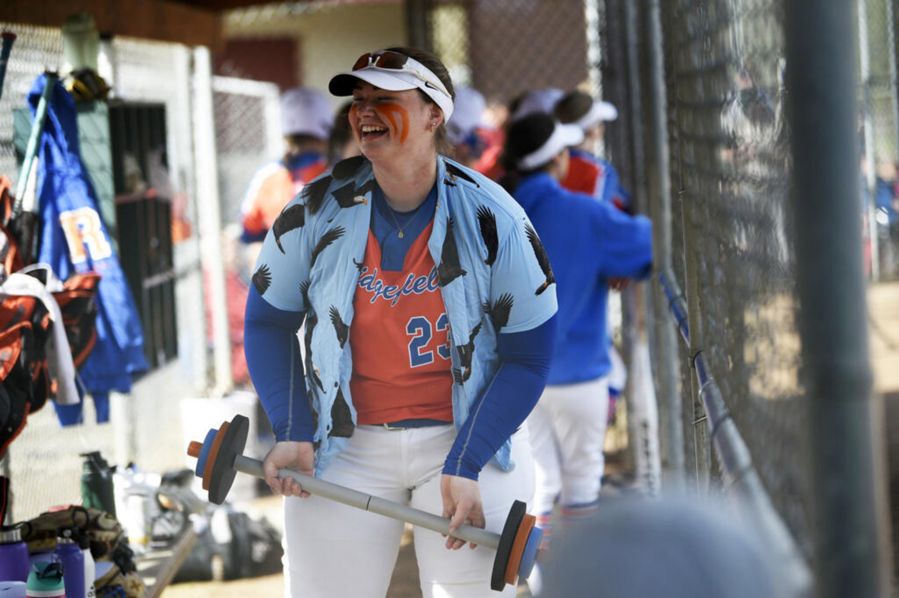 Maizy Whitlow holds a toy barbell in the dugout after hitting a first-inning home run during Ridgefield's 19-6 win over Columbia River in a 2A Greater St. Helens League softball game at VGSA on Thursday, April 13, 2023.