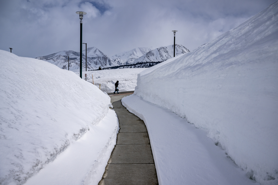 Giant snowbanks border a sidewalk on the Mammoth Lakes campus of Cerro Coso Community College on April 3.