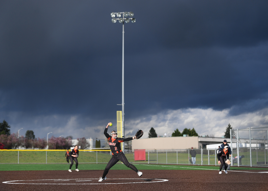 Battle Ground senior Rylee Rehbein pitches underneath dark clouds Wednesday, April 12, 2023, during the Tigers??? 4-0 loss to Skyview at Fort Vancouver High School.