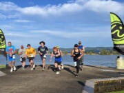 A wave of participants in the 2022 Lake to Bay start the first leg of the relay at Frenchman's Bar Regional Park along the Columbia River in Vancouver.