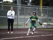 Evergreen’s McKayla White backtracks to third base as head coach Carrie Urban looks on during a 3A GSHL softball game on Friday, April 21, 2023, at Evergreen High School.