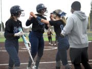 Skyview’s Jenna Stockton, center, celebrates with teammate Reese Perdue, right, after hitting a go-ahead solo home run in the seventh inning against Battle Ground on Friday, April 21, 2023, at Mountain View High School.