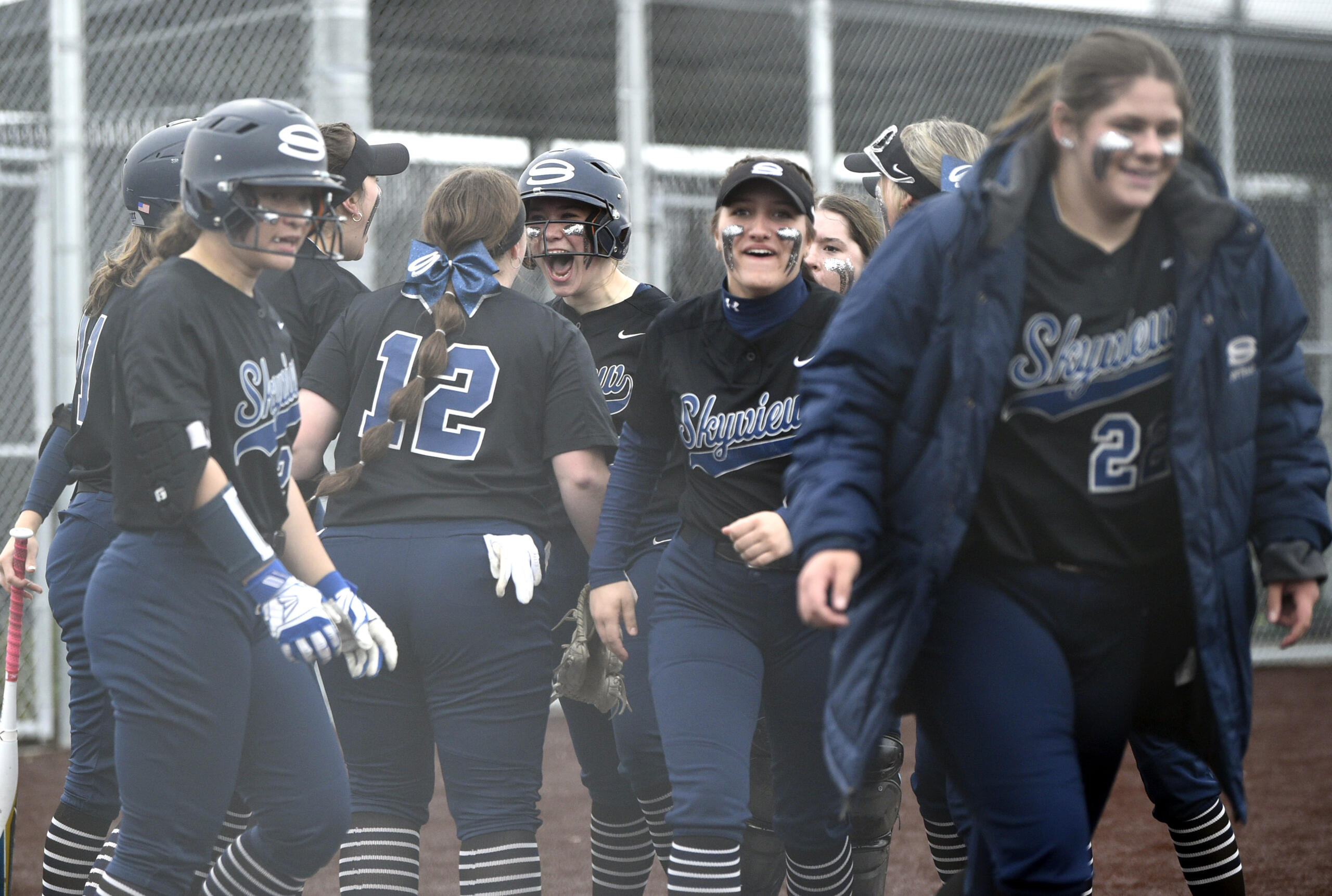 Skyview players greet Jenna Stockton at home plate after hte junior hit a go-ahead solo home run in the seventh inning against Battle Ground on Friday, April 21, 2023, at Mountain View High School.