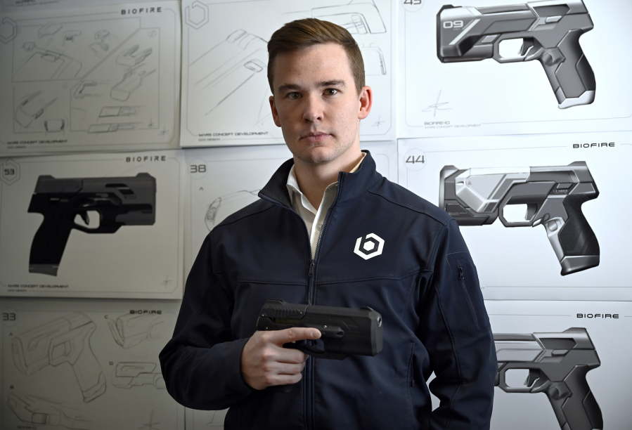 Kai Kloepfer, the founder and CEO of "smart gun" manufacturer Biofire Technologies Inc., stands for a portrait in the model room against product drawings at the company's corporate headquarters in Broomfield on Apr. 14, 2023.