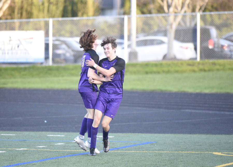 Columbia River's Alex Harris (right) celebrates a first-half goal with teammate Ryland Perron during Thursday's 2A GSHL match against Hockinson. River won, 7-0.