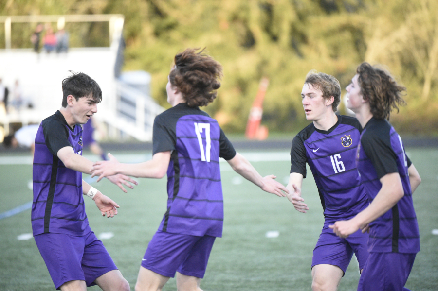 Columbia River players celebrate a goal by Ryland Perron (17) during Thursday's match against Hockinson.