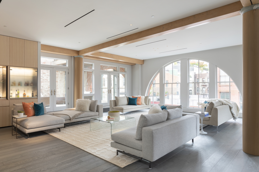 An expansive living room is kept open and airy through the use of neutral sofas and seating.