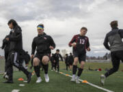 First generation Ukrainian American Denis Zayets, second from left, and Illia Strynada (13), a refugee from Ukraine, warm up with the soccer team before a match against Washougal at Fort Vancouver High School on Thursday, April 13, 2023.