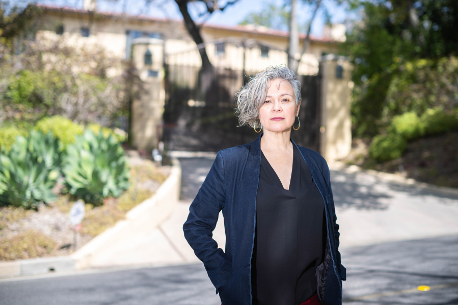 Gabriela Sandoval, executive director of the Excessive Wealth Disorder Institute, stands before home in San Marino, California, that is on the market for $21 million, on April 6, 2023.