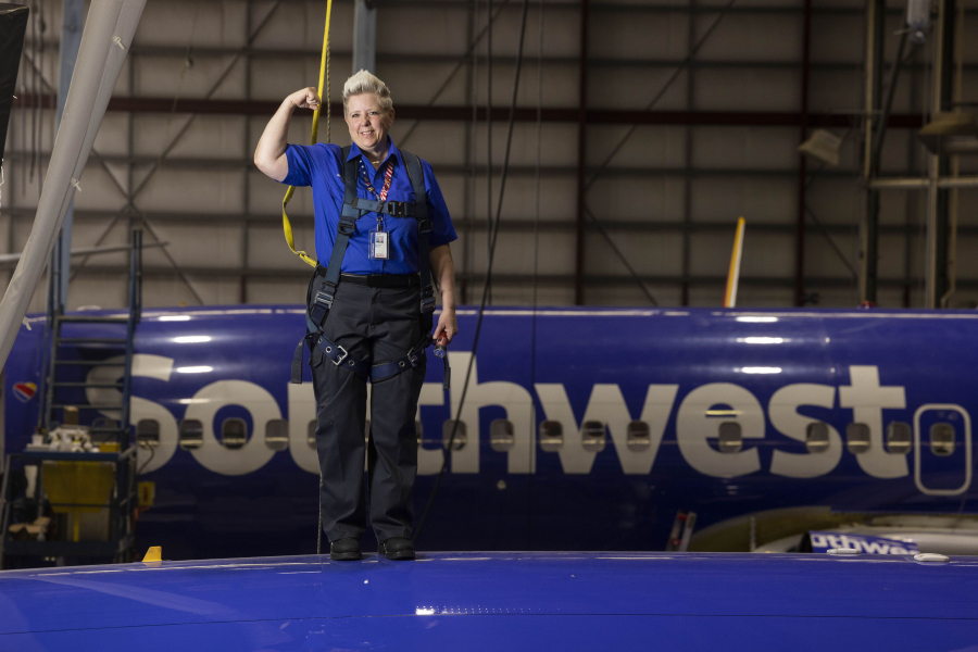 Jennifer Morgan, aircraft maintenance inspector, posed for a photo on top of a plane in Hangar 5 at the Southwest Airlines Headquarters in Dallas on Apr. 14, 2023.