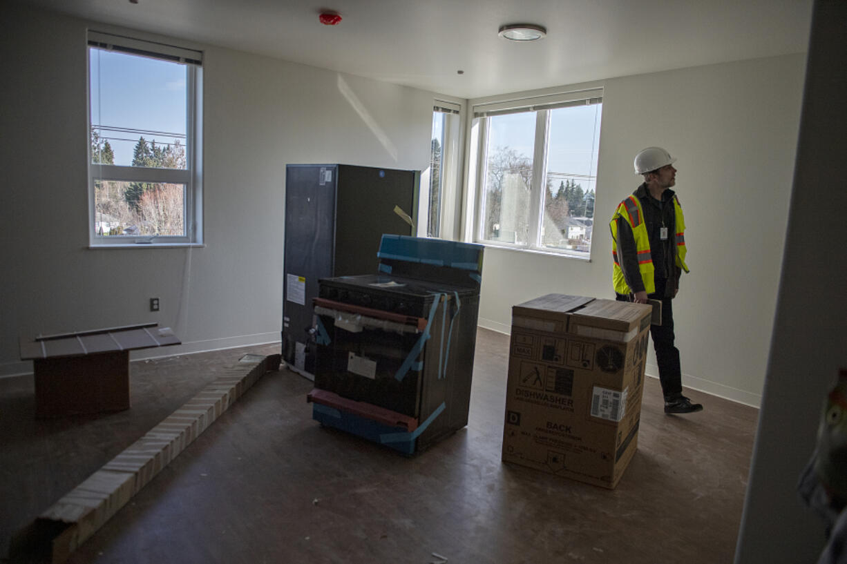 Scott Davidson, Vancouver Housing Authority construction project manager, walks through a two-bedroom corner unit at Fourth Plain Community Commons. The low-income development features triple-pane windows and energy-efficient appliances required by Washington's updated energy code regulations.