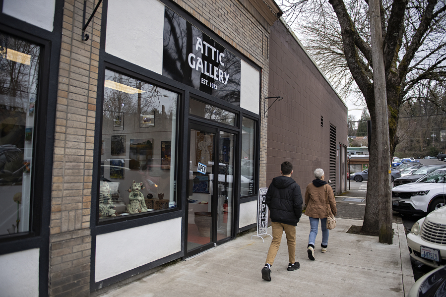 Pedestrians stroll past the Attic Gallery in downtown Camas on a recent Friday morning.
