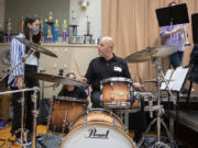 Senior Mei Schillen, 18, listens to some drumming tips from longtime pro Gary Hobbs, who volunteers occasionally at Vancouver School of Arts and Academics. "The vibe here is so healthy, and they are such talented kids," Hobbs said.