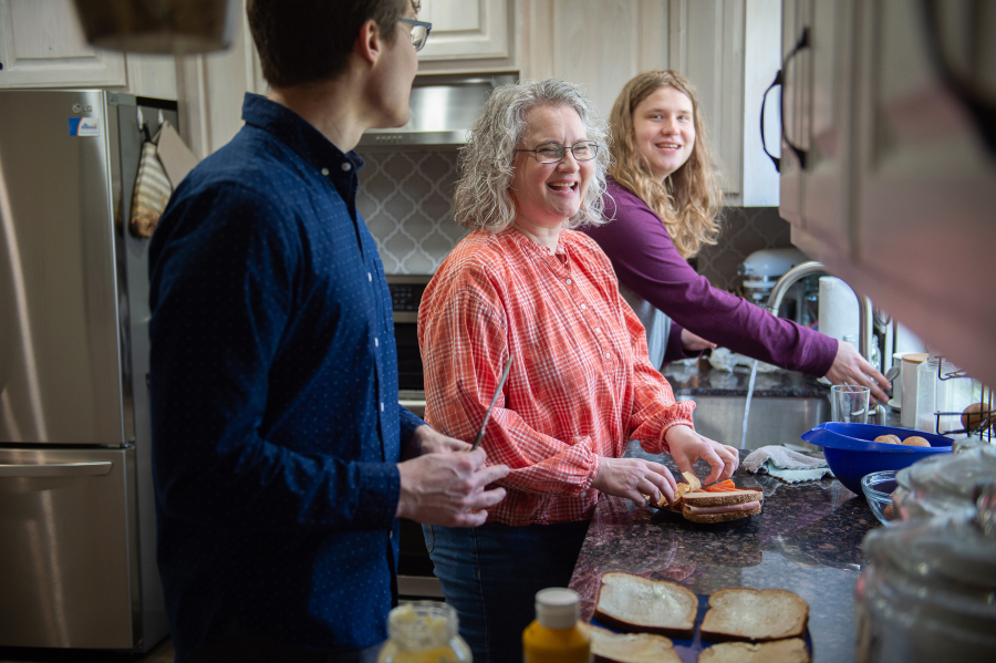 Ingela Martinson, center, prepares lunch with her sons Andreas, left, and Nathan, right, during a break from watching the The Church of Jesus Christ of Latter-Day Saints general conference broadcast on April 1. They are mourning the death of Göran Martinson, husband and father. Their faith's promise of eternal families sustains them.