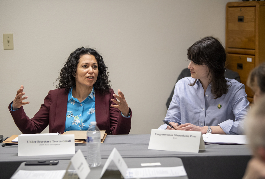 3rd Congressional District Rep. Marie Gluesenkamp Perez, D-Skamania, right, listens to  U.S. Department of Agriculture undersecretary Xochitl Torres Small answer a question Tuesday during a roundtable at Our American Roots farm in Woodland.