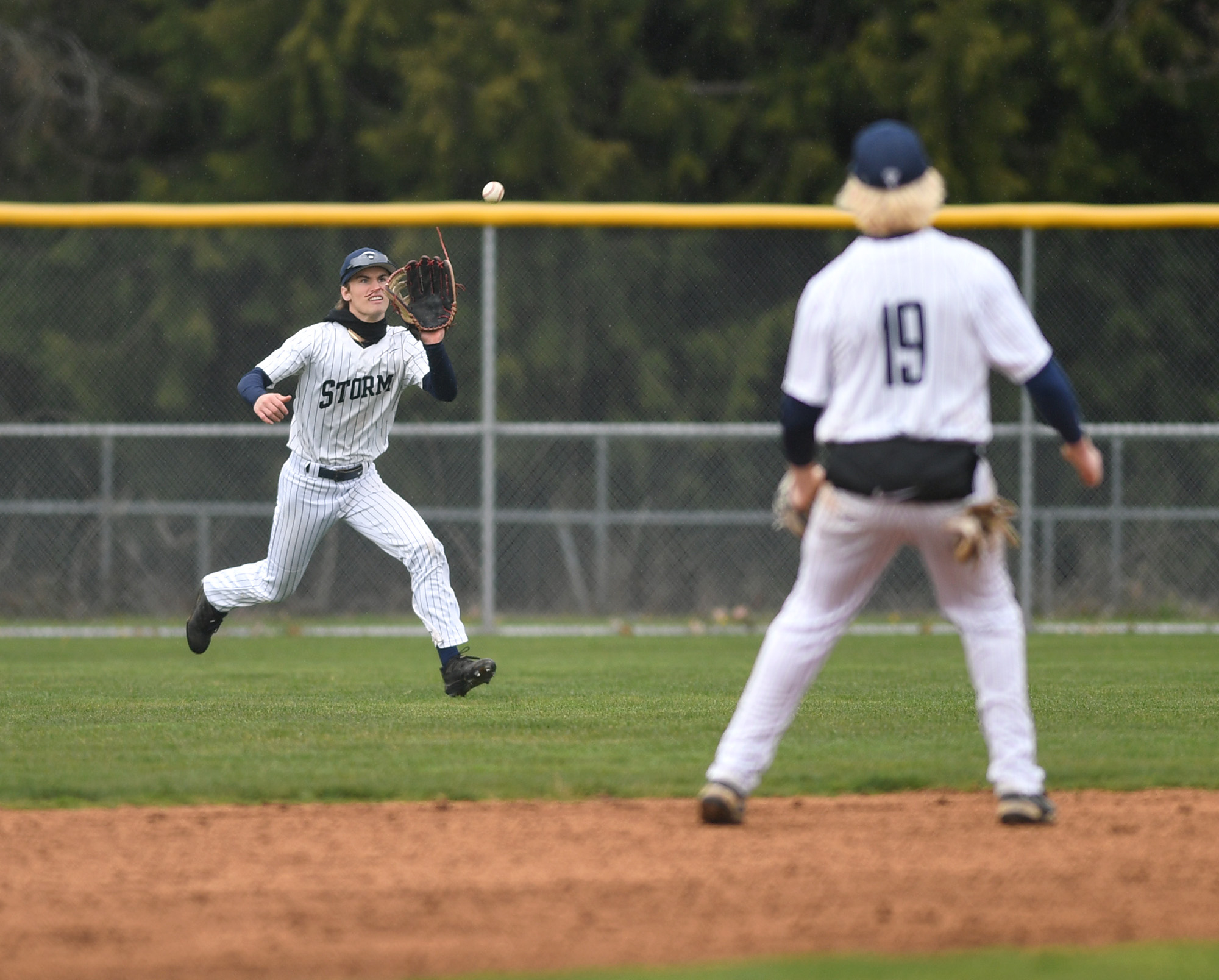Skyview senior Jack Santic, left, catches the ball Wednesday, April 5, 2023, during the Storm’s 6-2 win against Prairie at Skyview High School. It was Skyview’s first game at its home stadium in 7 years.