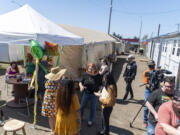 People enjoy the sunshine Friday, April 28, 2023, during a celebration of the 1-year anniversary of the Hope Village Safe Stay community on Fourth Plain Boulevard.