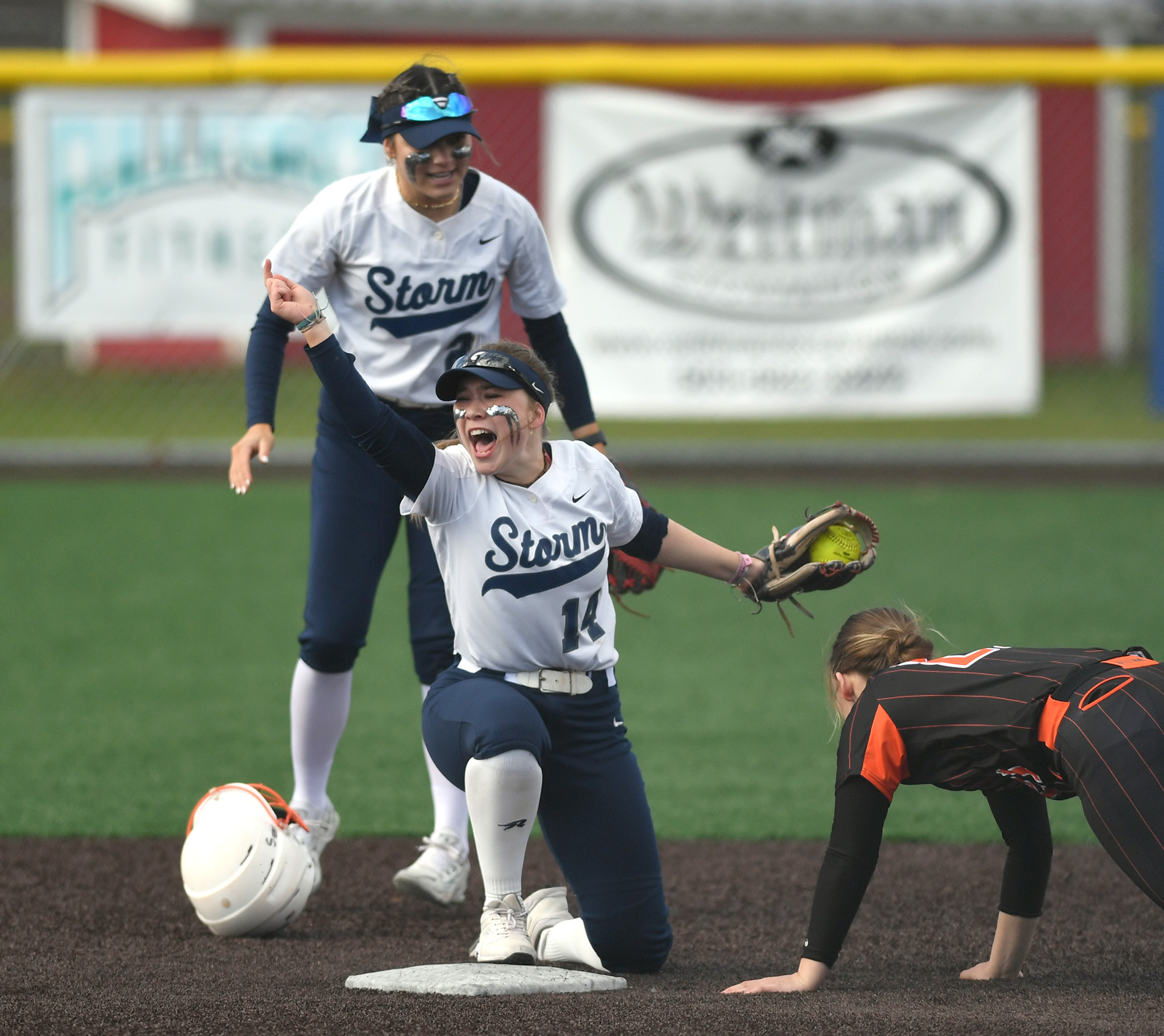 Skyview junior Jenna Stockton, center, celebrates after tagging out a Battle Ground runner Wednesday, April 12, 2023, during the Storm’s 4-0 win against Battle Ground at Fort Vancouver High School.