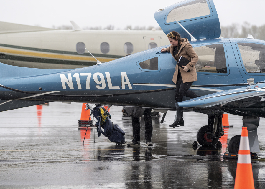 Pilot Margaux Retherford steps out of a KinectAir Diamond DA62 at Atlantic Aviation PDX in Portland. The on-demand airline can land at any public airport in the region.
