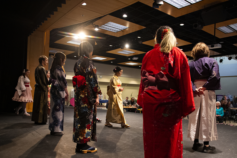 Members of the Clark College Japanese Club greet the audience while taking part in a fashion show during the annual Sakura Festival on Thursday afternoon. More than 30 years ago, the city of Vancouver received a gift of friendship: 100 Shirofugen cherry trees, commemorating the 100th Anniversary of Washington's statehood.