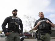Deputies Josh Troyer, left, and Lanny Kipp wear Axon body-worn cameras on their vests Monday at the Clark County Sheriff's Office West Precinct in Ridgefield. They are participating in a 30-day test period for the body and vehicle cameras.