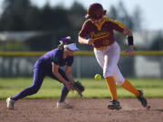 Prairie freshman Mackenzie Moore, right, dashes to third base Thursday, April 27, 2023, during the Falcons’ 2-1 win against Heritage at Prairie High School.