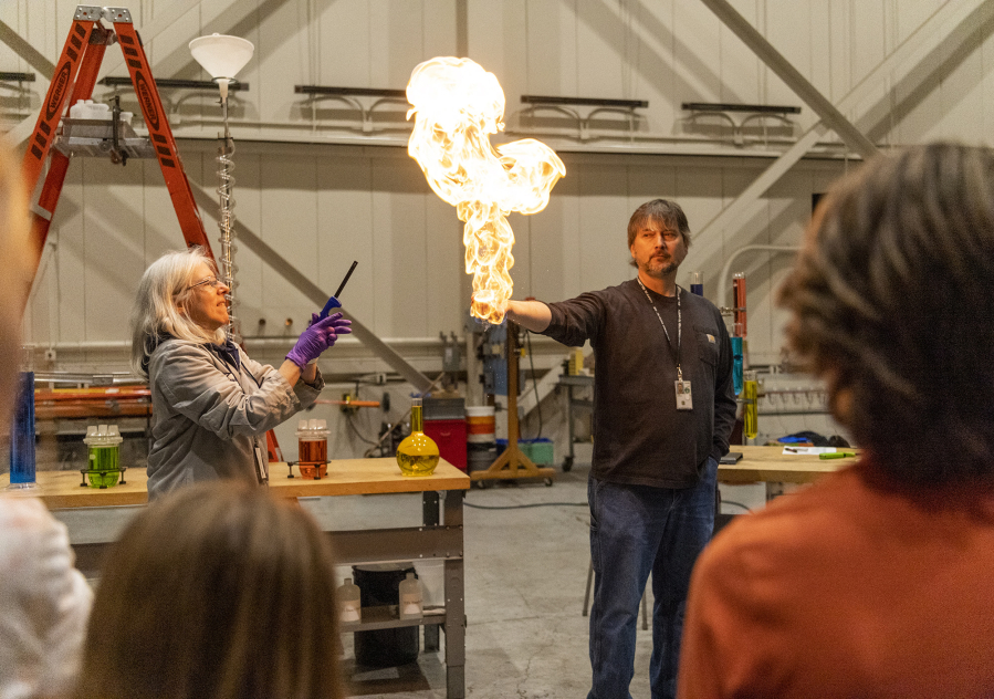 Bonneville Power Administration electrician foreman Steve Hood holds a flaming pillar of methane gas in his hand as part of a demonstration about chemical mixtures Thursday during Take Your Child To Work Day at Bonneville Power Administration's Ross Complex in Vancouver.