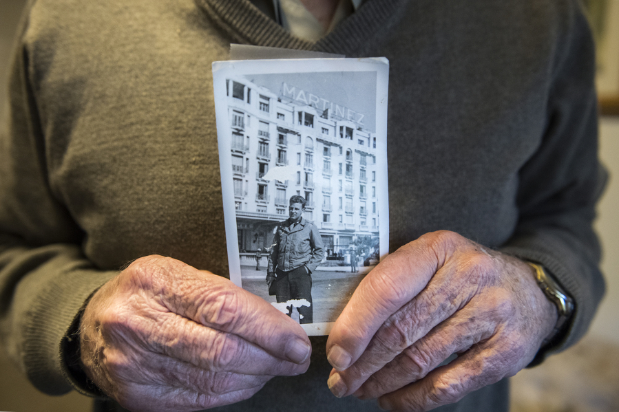 Bill Marshall shows off a photo of himself in Cannes, France, during World War II in this 2018 photo.