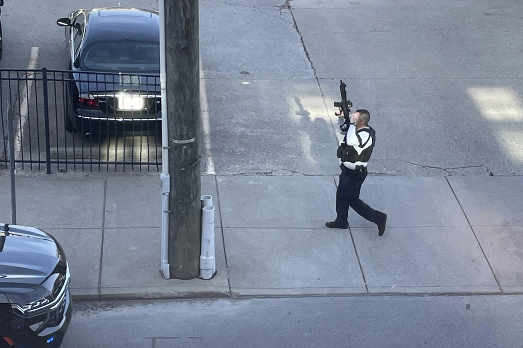 This photo provided by Reid Cornell shows police presence near the scene of a shooting in Louisville, Ky., Monday, April 10, 2023.