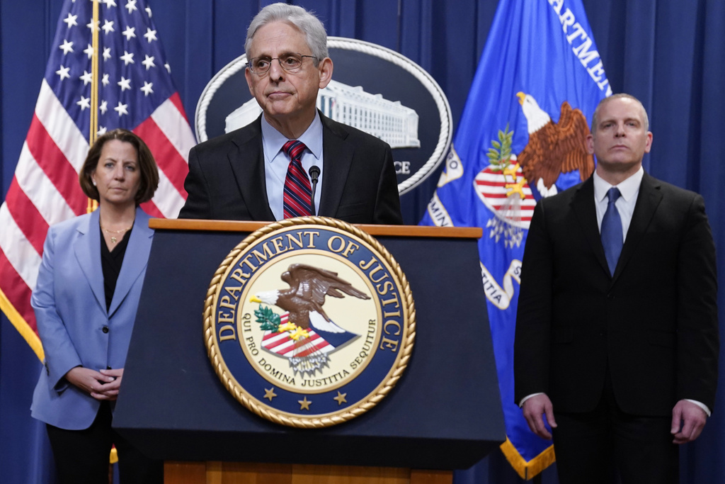 Attorney General Merrick Garland speaks at the Department of Justice in Washington, Thursday, April 13, 2023. FBI Deputy Director Paul Abbate, right, and Deputy Attorney General Lisa Monaco, left, listen.