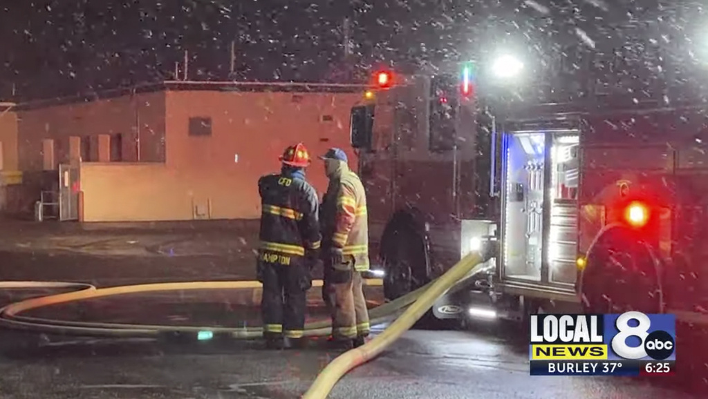 In this image taken from video from KIFI Local News 8, firefighters work on the scene of an early morning fire at a large high school in Pocatello, Idaho, Friday, April 21, 2023. The Pocatello Fire Department said the fire at Highland High School was reported just before 4 a.m., and when firefighters arrived they found flames showing above the building amid heavy snowfall. The school has roughly 1,500 students, making it one of the largest in Idaho.