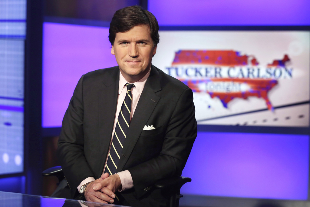 FILE - Tucker Carlson, host of "Tucker Carlson Tonight," poses for photos in a Fox News Channel studio on March 2, 2017, in New York.