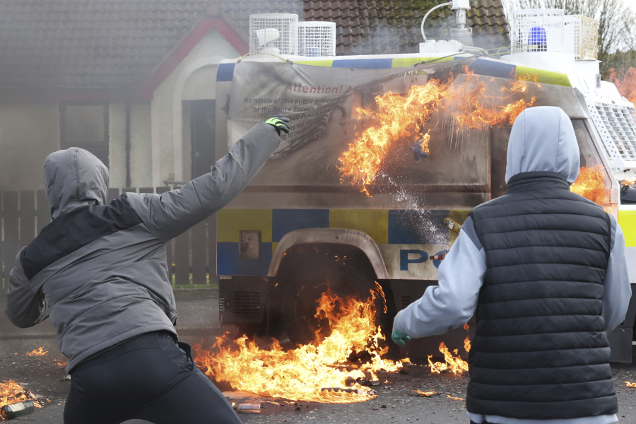 Masked youths throw petrol bombs at a police Land Rover as Republican protesters opposed to the Good Friday Agreement hold a parade Monday in Londonderry, Northern Ireland.